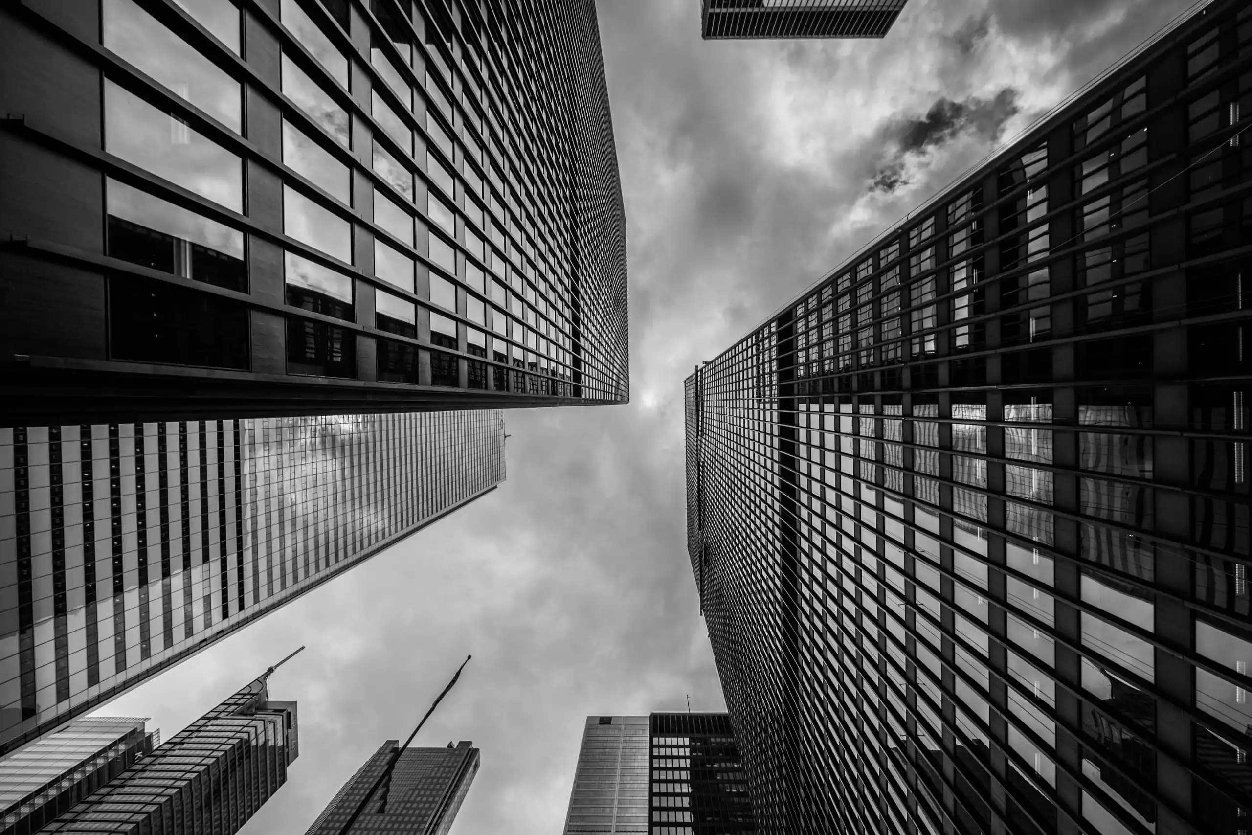 A ground level view of skyscrapers which are often synonymous with businesses and partnerships. For Youmoni, collaboration is an intergral part of our business.